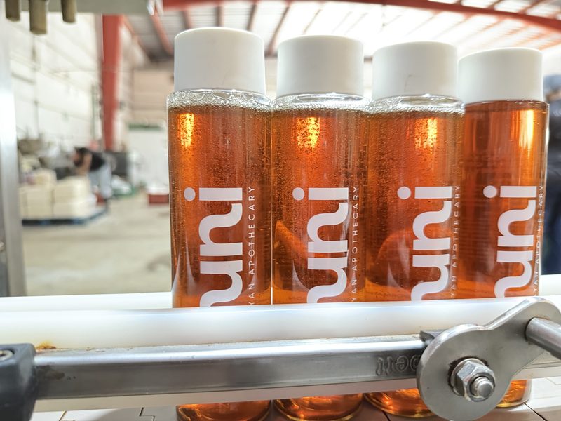 huni shampoo bottles on the factory production line